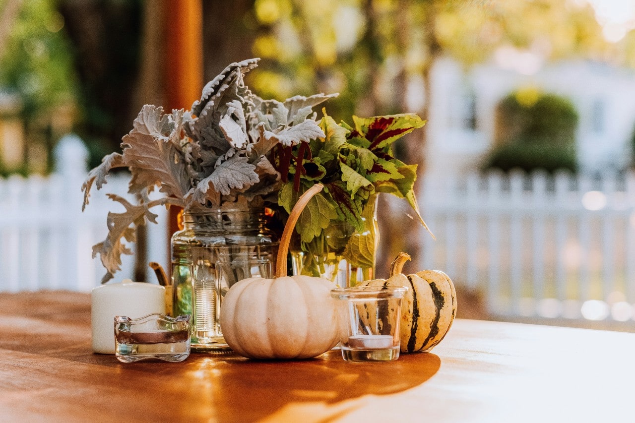 a wedding table set for a fall wedding with autumn-themed decorations