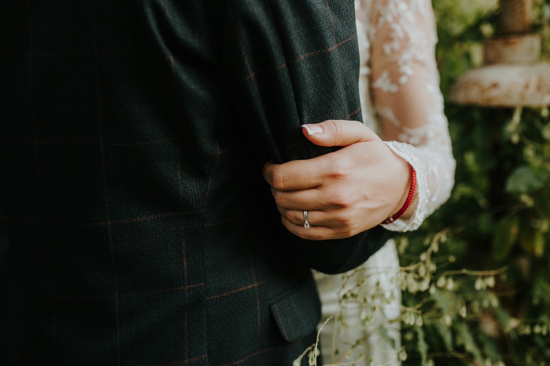 a man and lady embracing with the woman wearing a diamond wedding band