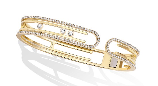 A yellow gold diamond bangle bracelet with unique diamond details from Messika Move, available at Kirk Jewelers.