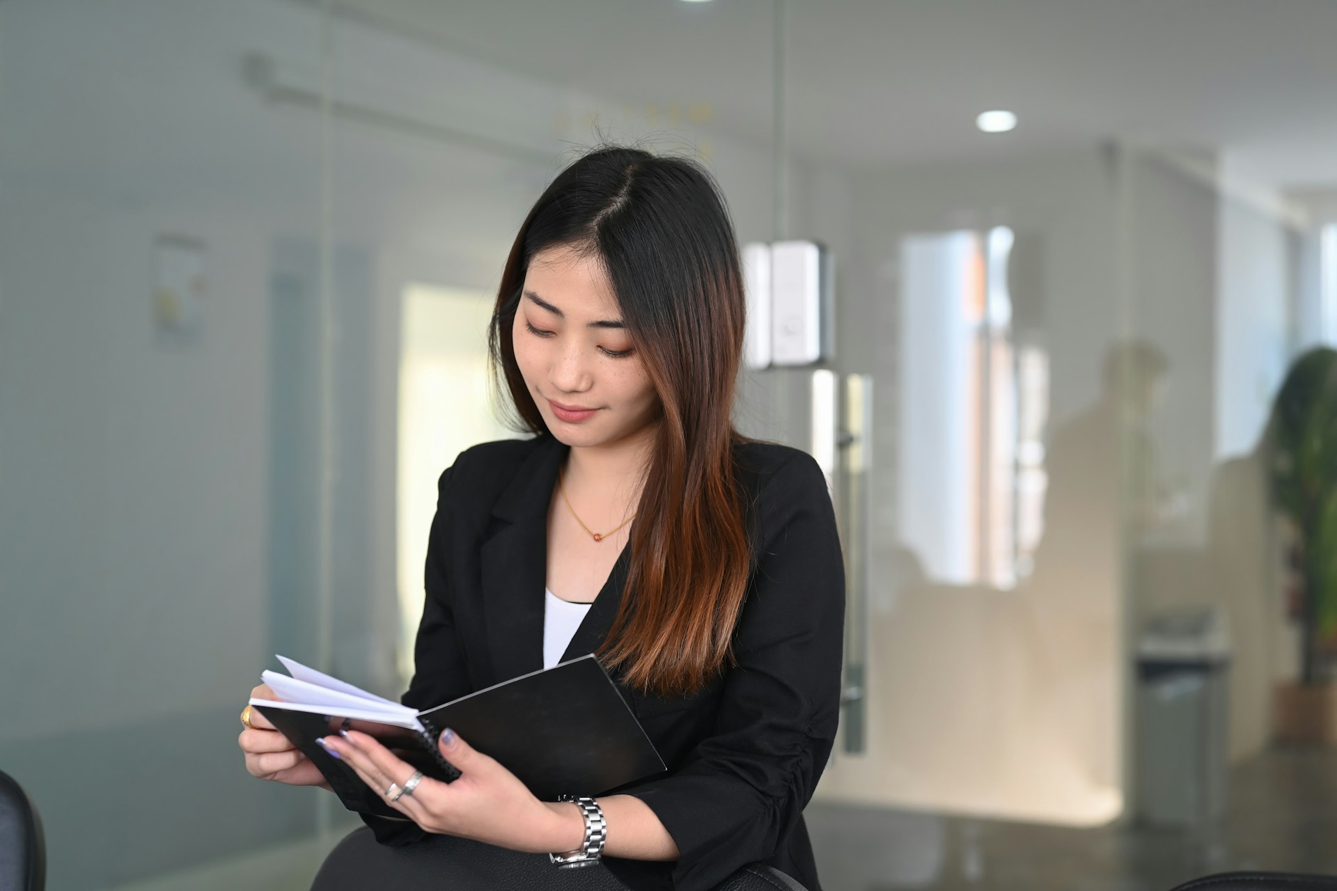 a lady reading a book and wearing luxury watch