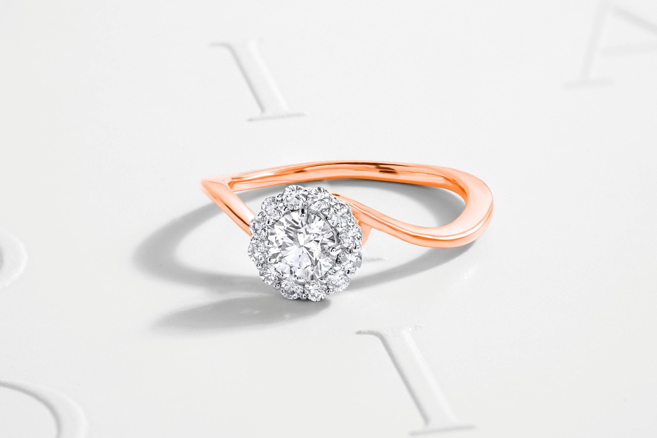 A close-up of a unique engagement with a distinctive rose gold band.